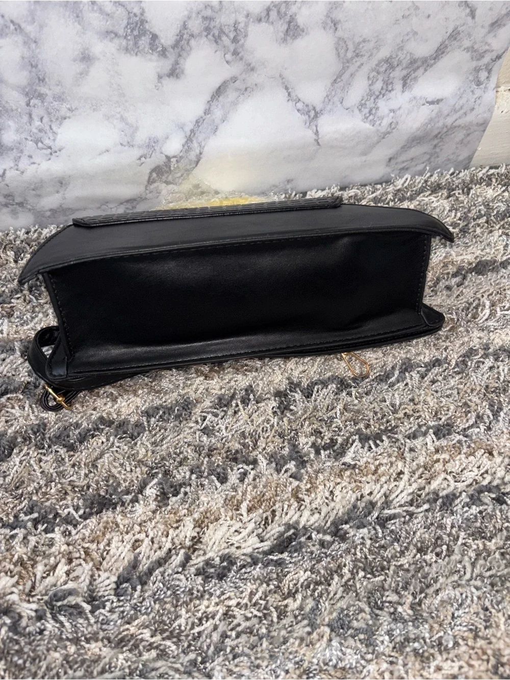 Elegant Black Textured Clutch with Gold Accent Handle